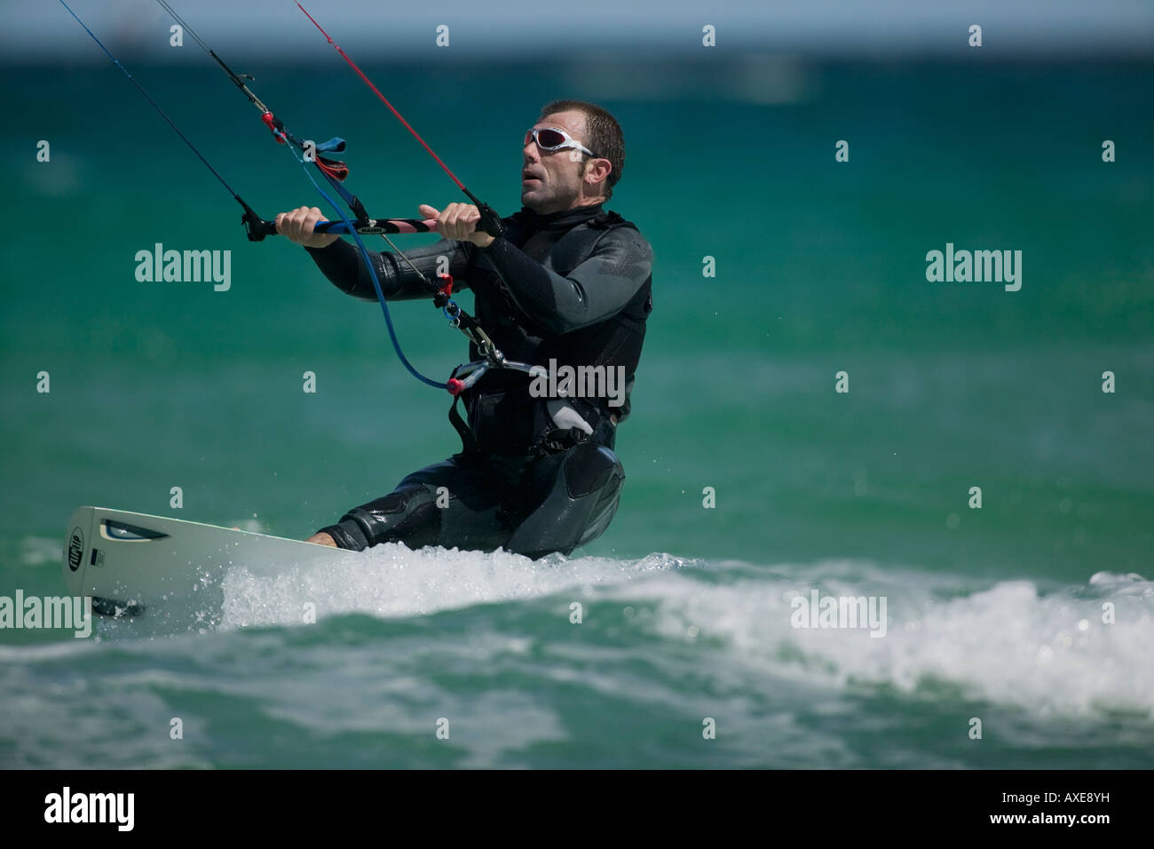 South Africa Western Cape Province Cape Town MR Kite surfer rides through breaking waves at Fish