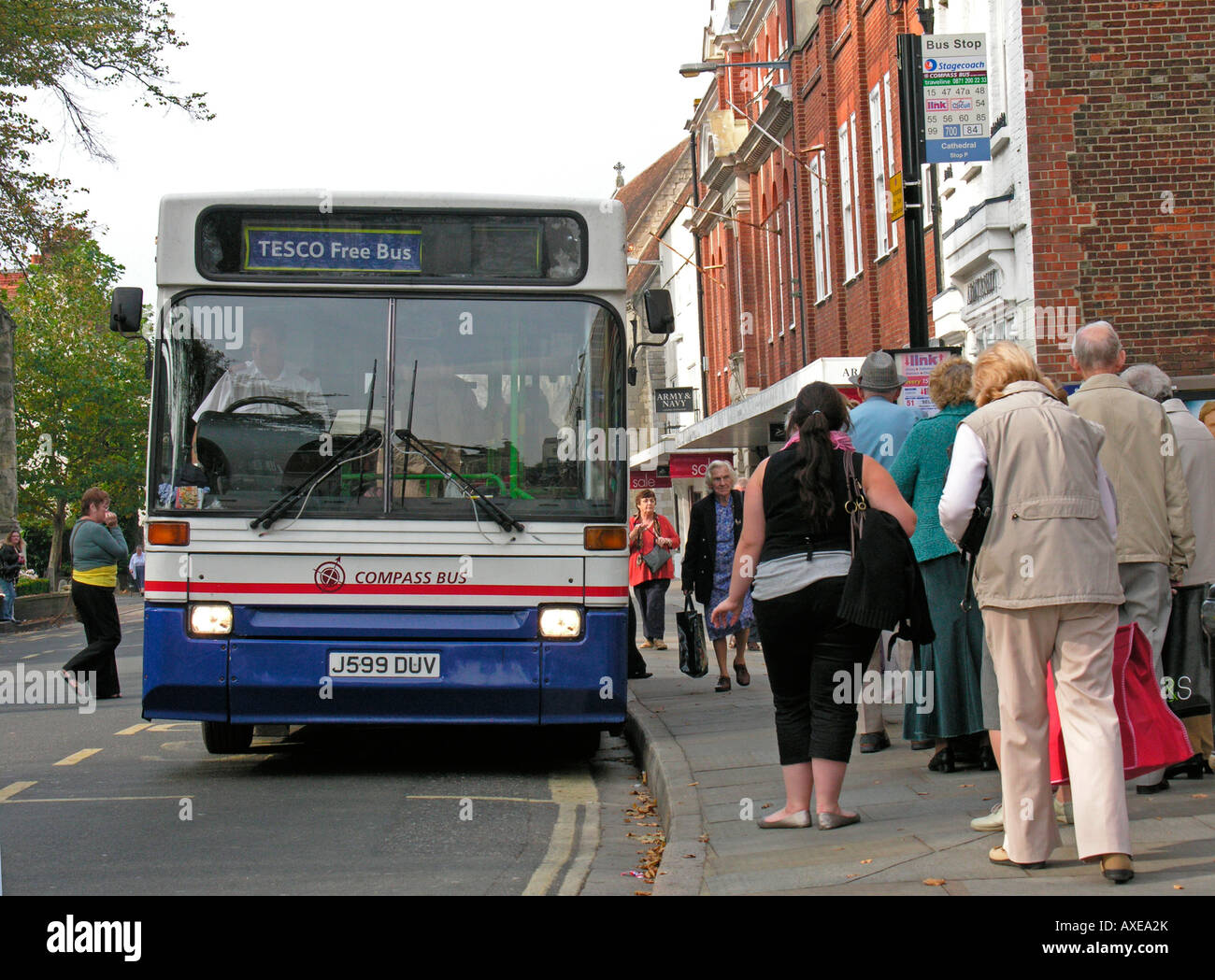 people queueing and getting on a Compass free Tesco bus in Chichester West Sussex Stock Photo
