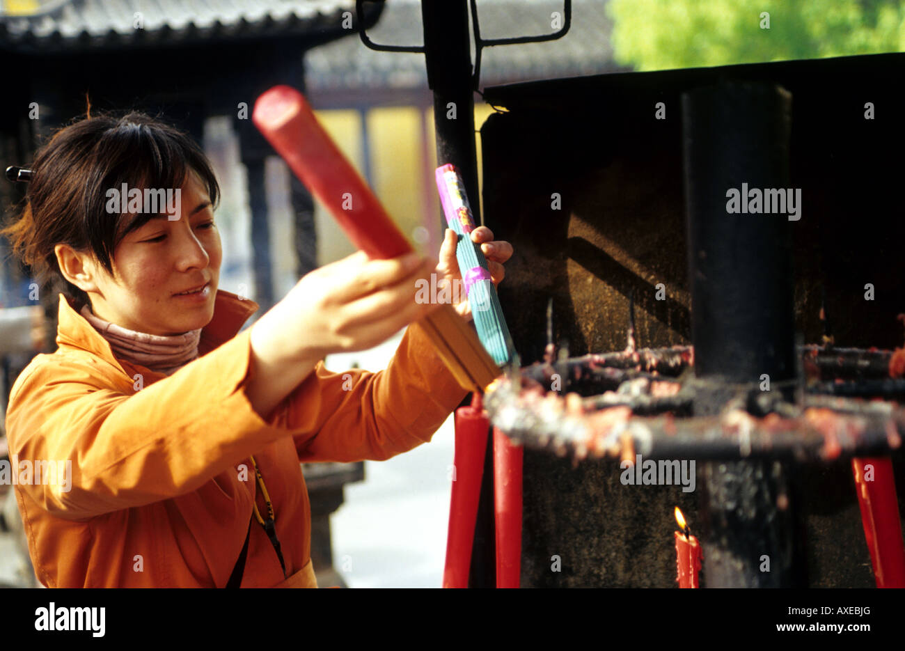Lighting the incense sticks in a Chinese temple Stock Photo - Alamy
