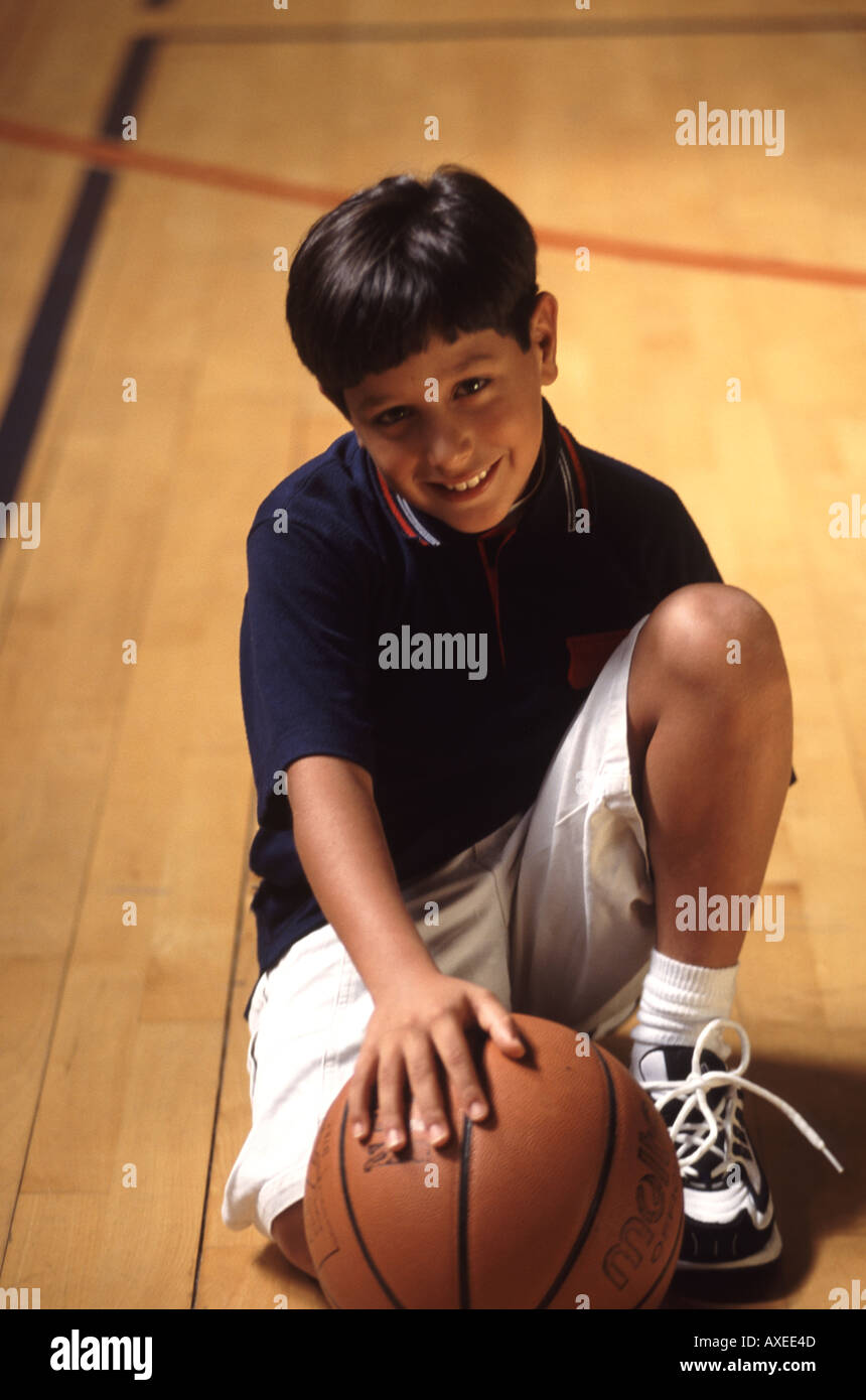 Young Jordanian boy with ball on basketball court in Amman Stock Photo