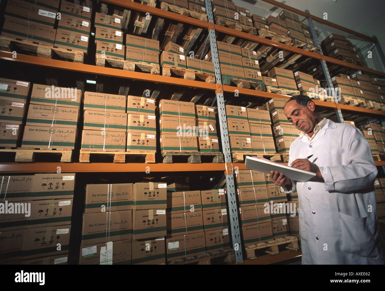Jordanian warehouse manager checks inventory in pharmaceutical plant near Amman Jordan Stock Photo