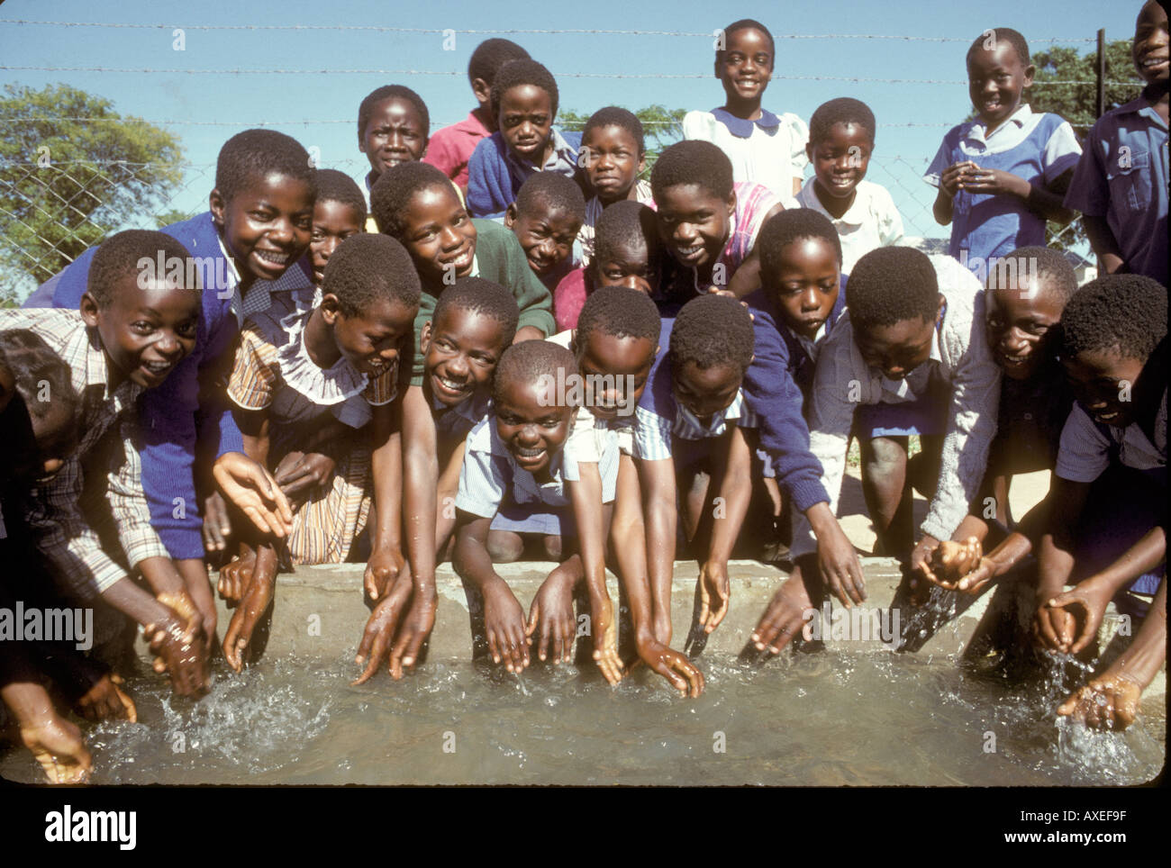 Africa Zimbabwe School children with their fresh water Stock Photo