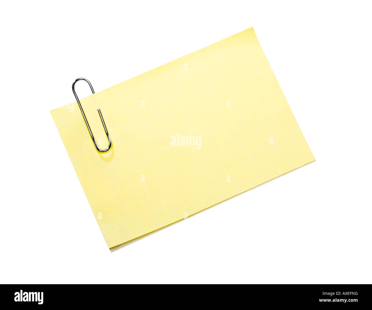 Yellow post it note and paper clip with shadow Stock Photo