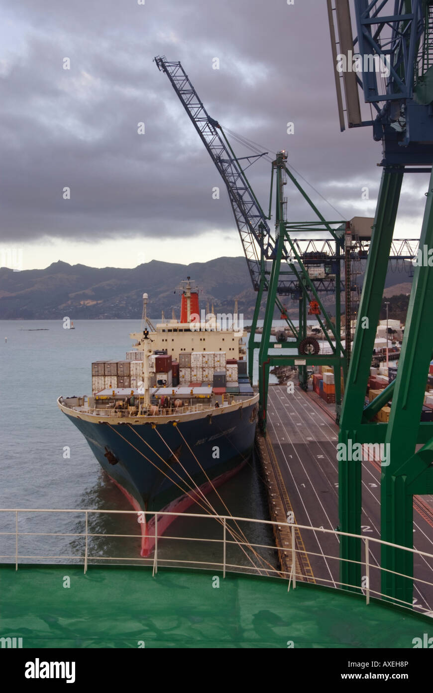 A container ship at her berth in Lyttelton New  Zealand as viewed from a car ship. Stock Photo