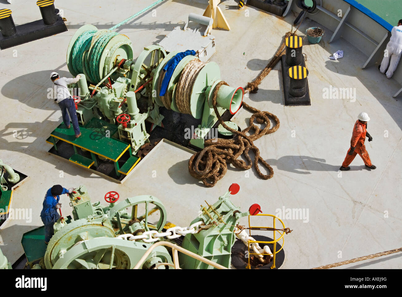 Ship's crew at work on foredeck of a car carrier during mooring