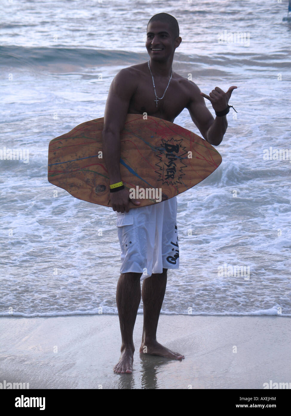 Young boy holding a skimboard table at Choroni beach, Venezuela Stock