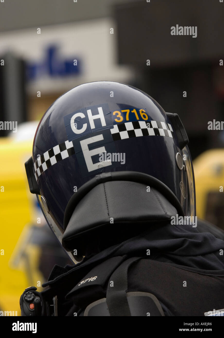 Police officer wearing anti riot helmet back view Stock Photo - Alamy