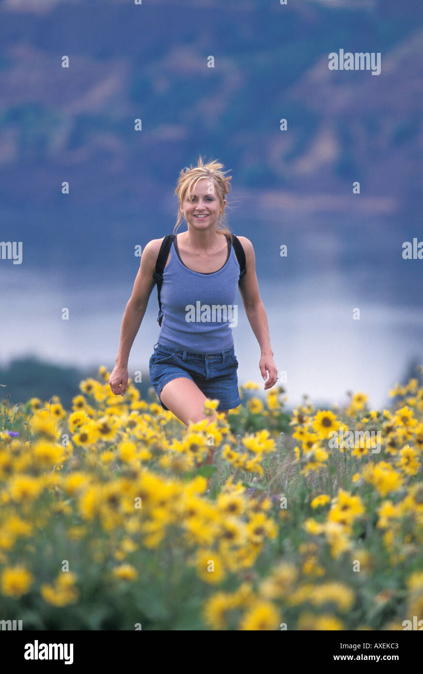 Woman hiking on field at hi-res stock photography and images - Alamy