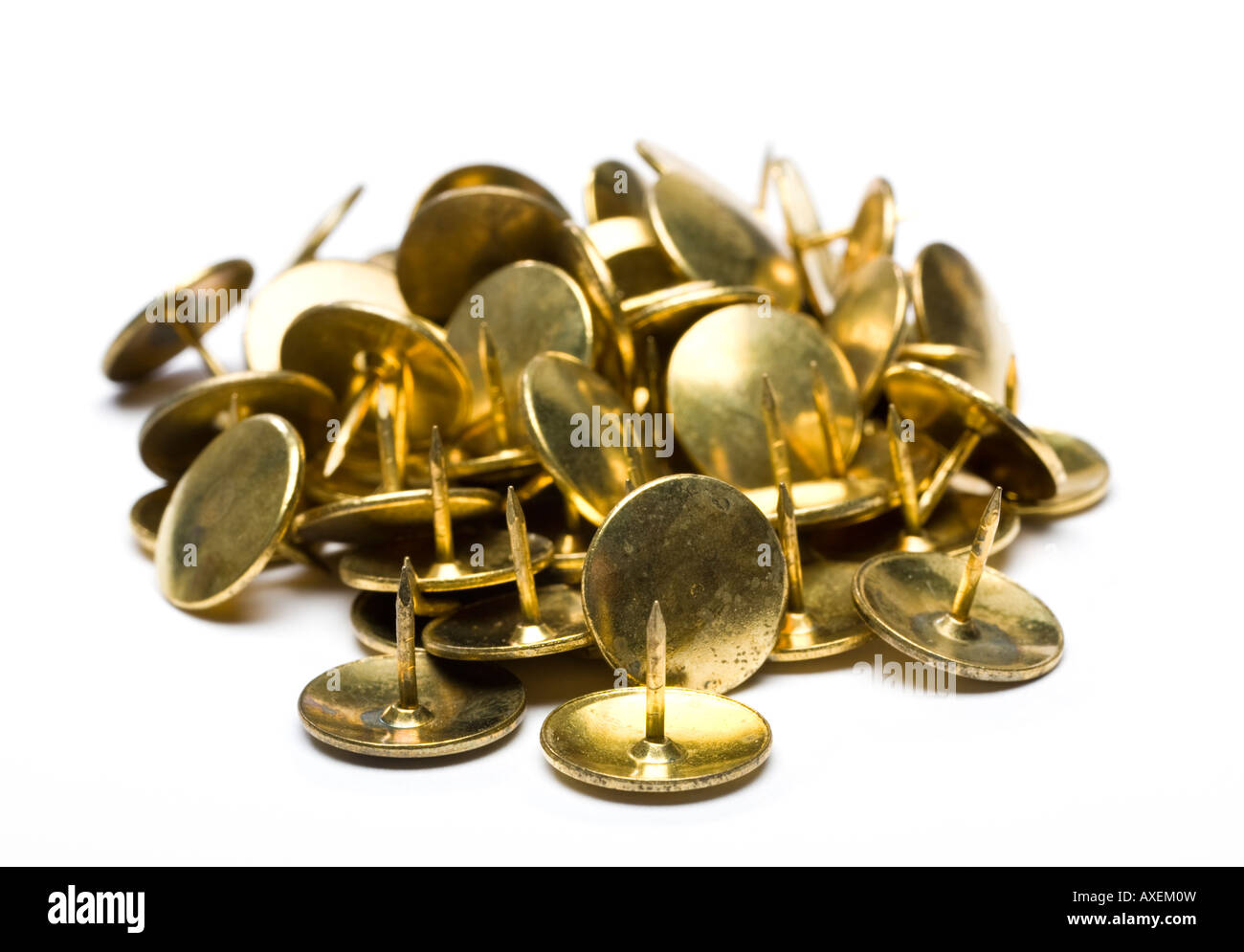 Pile of gold drawing pins on white background cut out silo Stock Photo