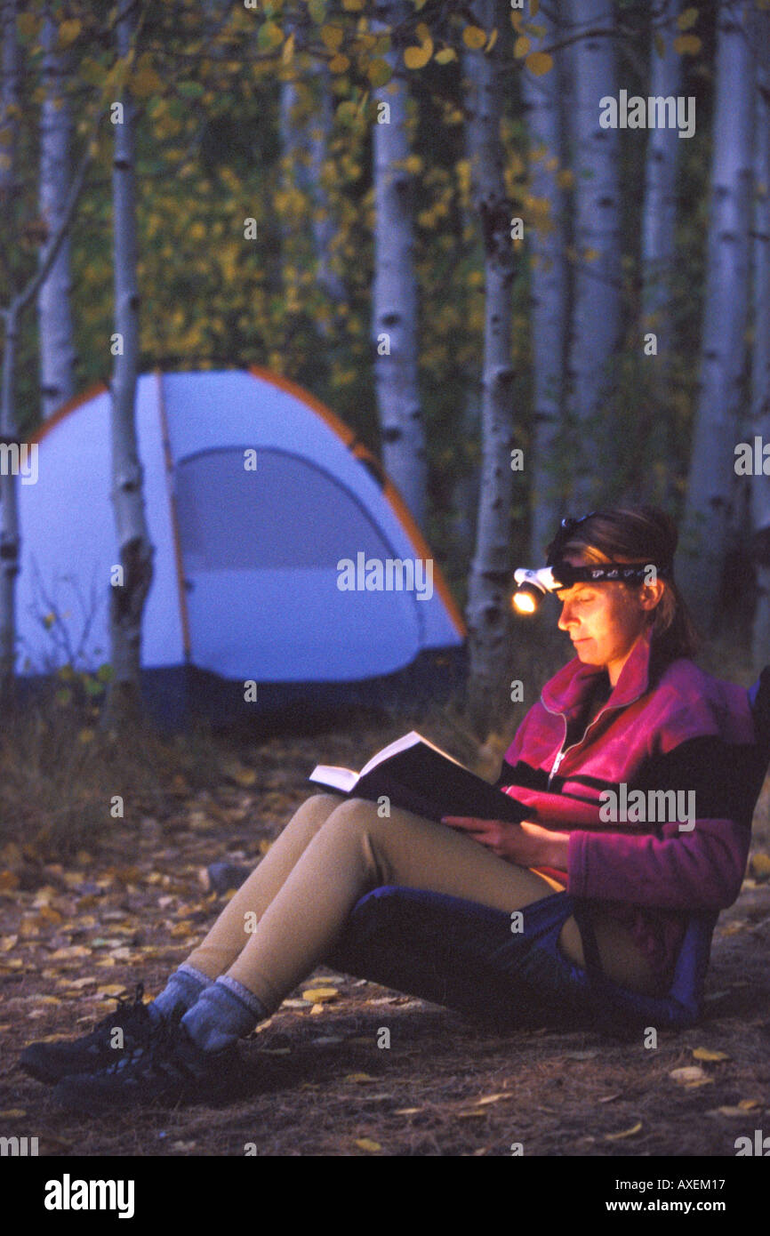 Woman Reading With Headlamp at Campsite in Woods Stock Photo Alamy