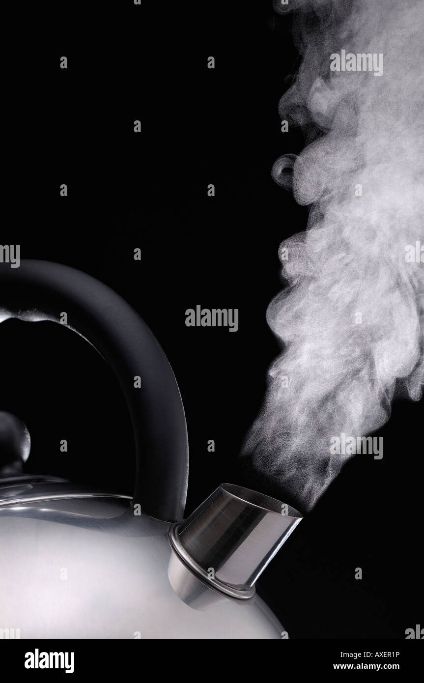 Steaming kettle Against a Black Background Stock Photo