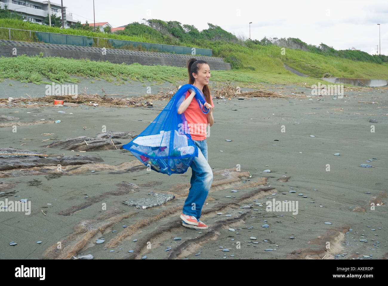 Woman carrying garbage bag hires stock photography and images Alamy