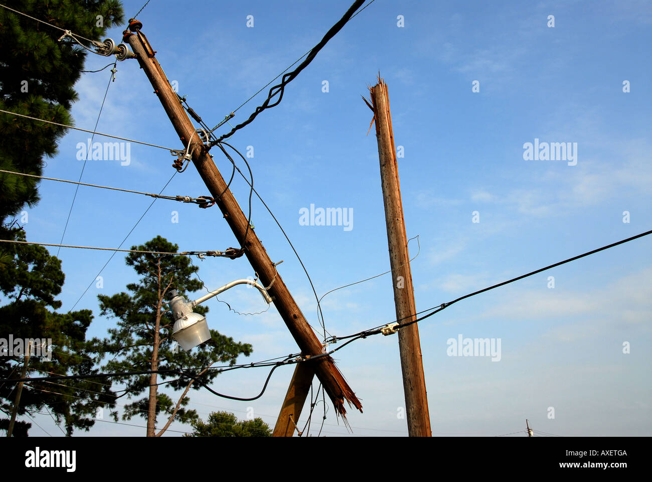 Storm damage hurricane electric power pole snapped by strong wind Stock Photo