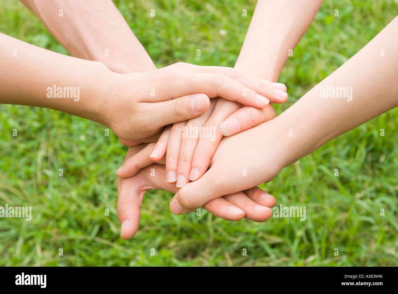 People stacking hands on top of each other Stock Photo - Alamy