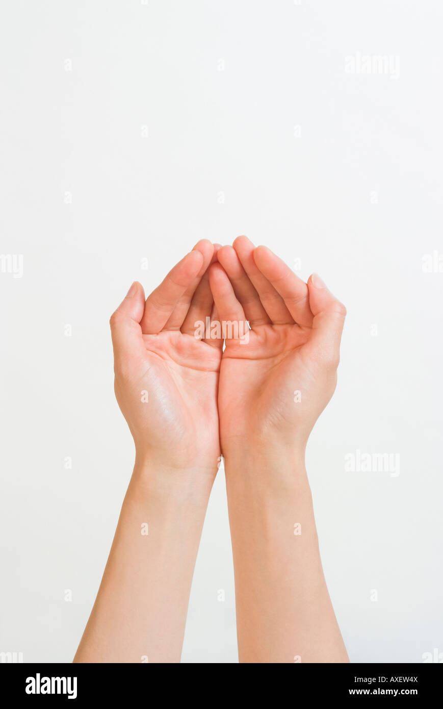 Woman holding out cupped hands Stock Photo