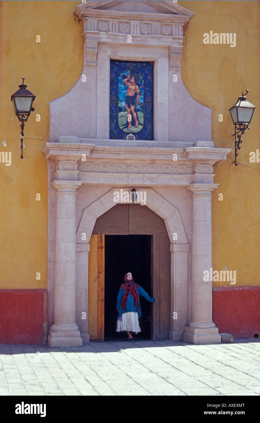 Elderly woman entering the church in the village of San Sebastian Bernal, Querétaro state, Mexico Stock Photo