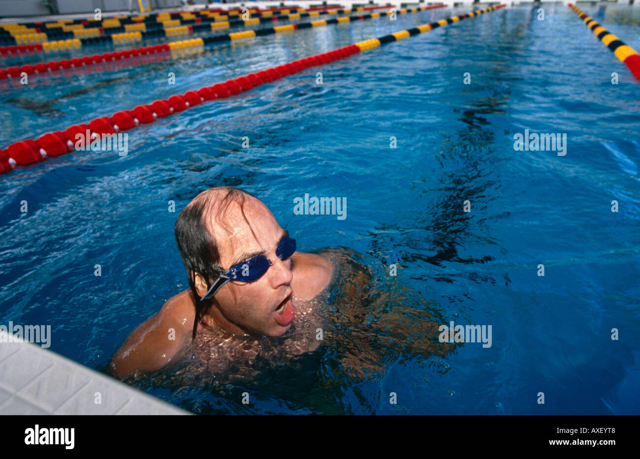 Male swimmer draws breath after a length in the Atlanta Olympic pool Stock Photo