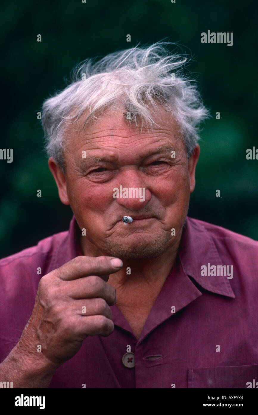 A traditional farmer smokes a cigarette in rural Hungary, Europe. Stock Photo