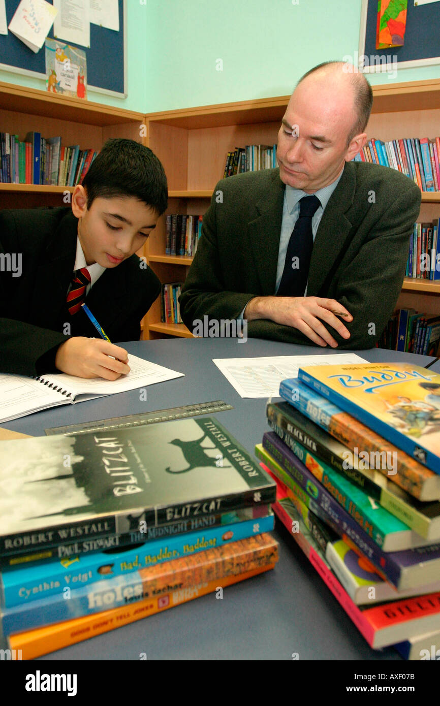 English Teacher assessing year 7 students in reading and writing Key stage 3. Stock Photo