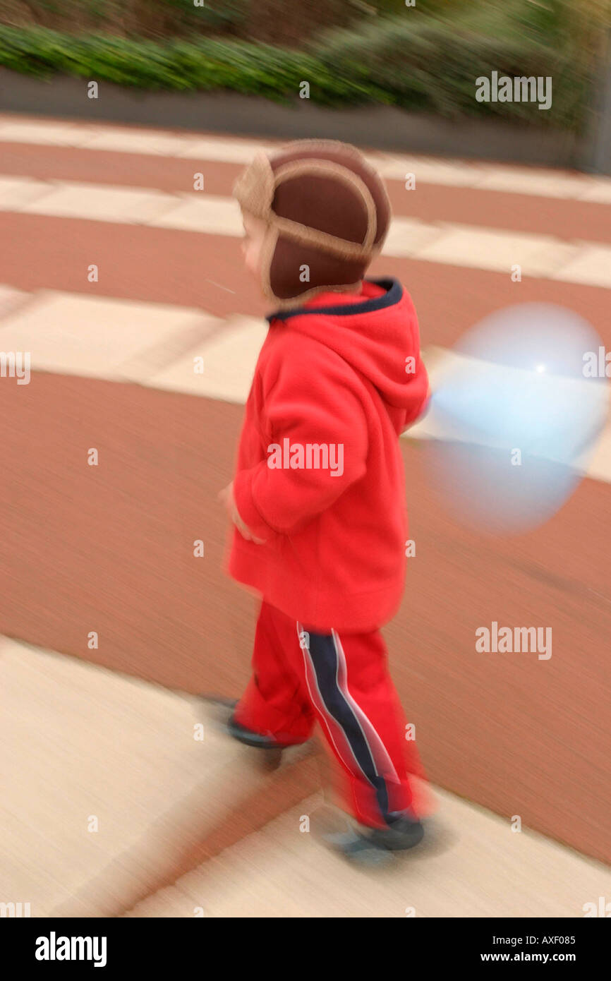 Young child running off and laughing Stock Photo Alamy