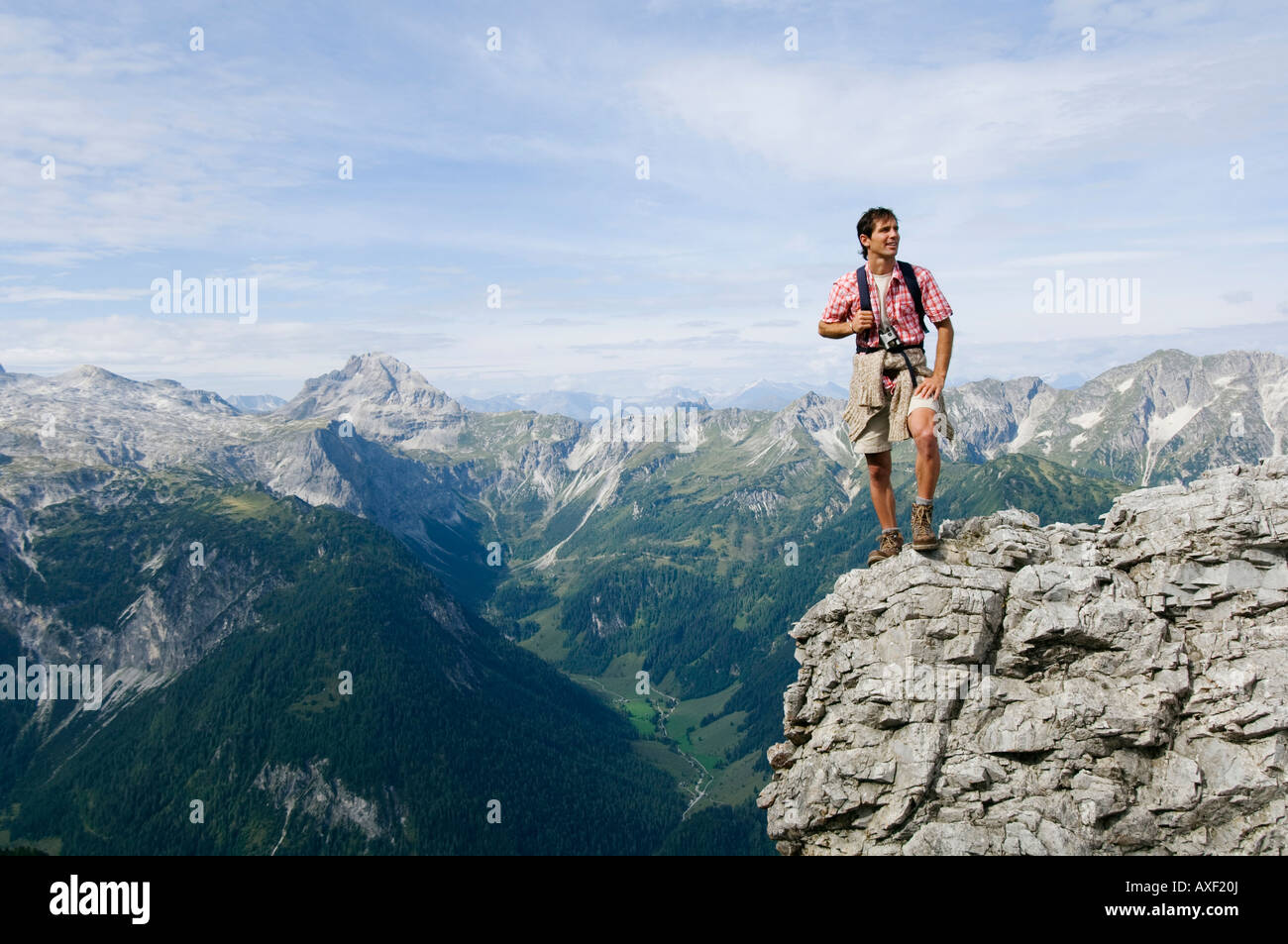 Austria, Salzburger Land, young man on mountain top Stock Photo