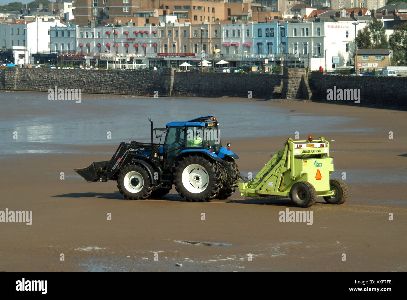 Weston Super Mare beach and early morning tractor pulling litter