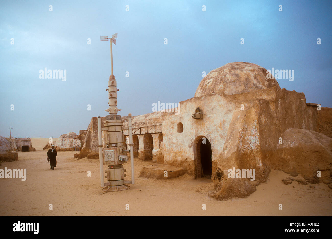 Arab man walking in the remains of the Star Wars set now a tourist attraction in the desert Tunisia Africa Stock Photo