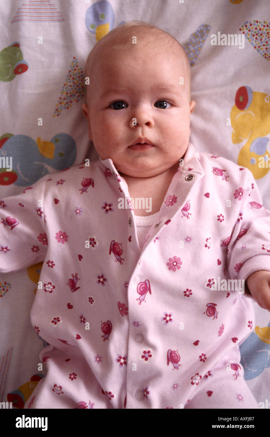 indoor flat child baby 0 5 lie cot bed portrait vertical Stock Photo