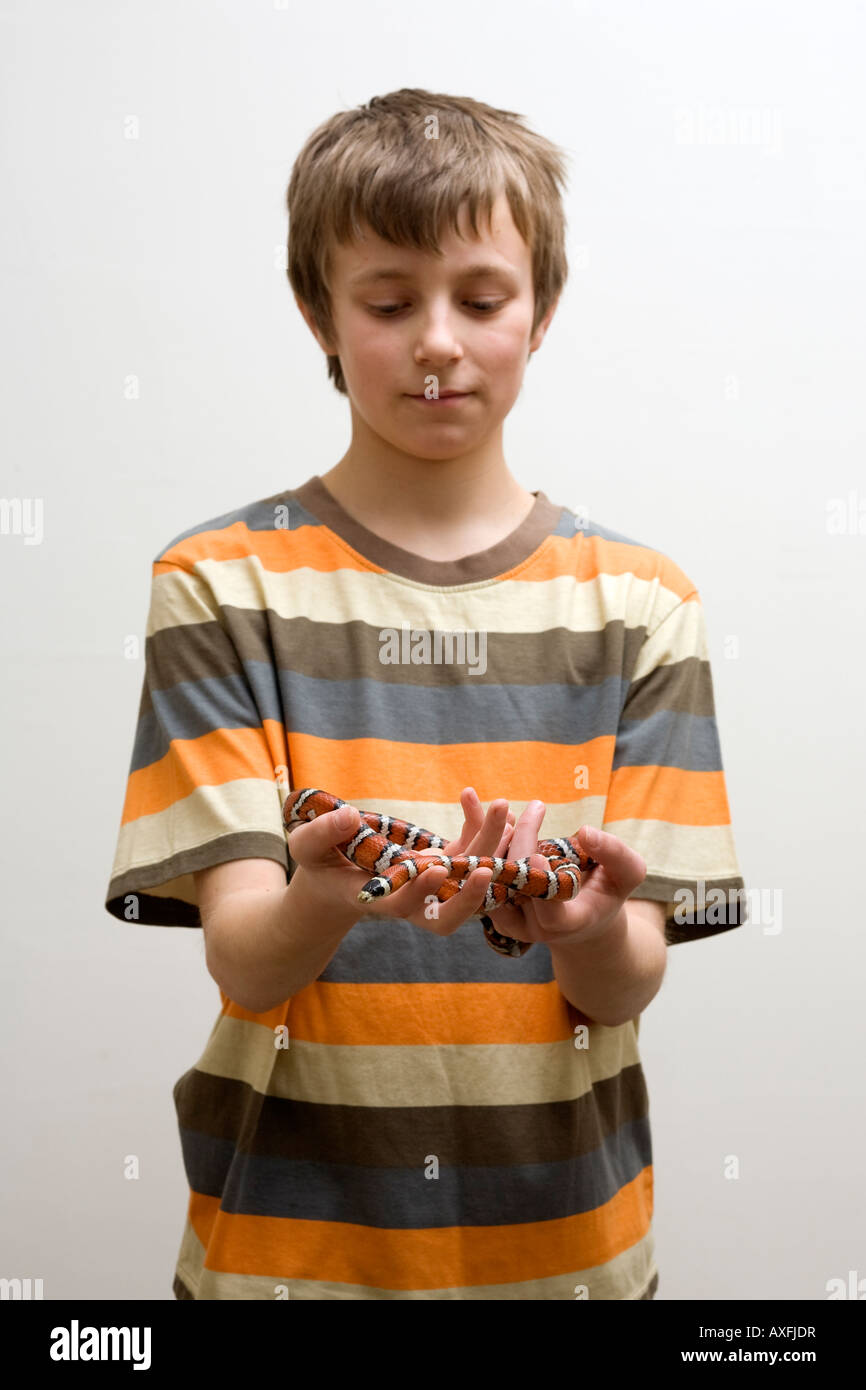 Boy holding pet snake Stock Photo