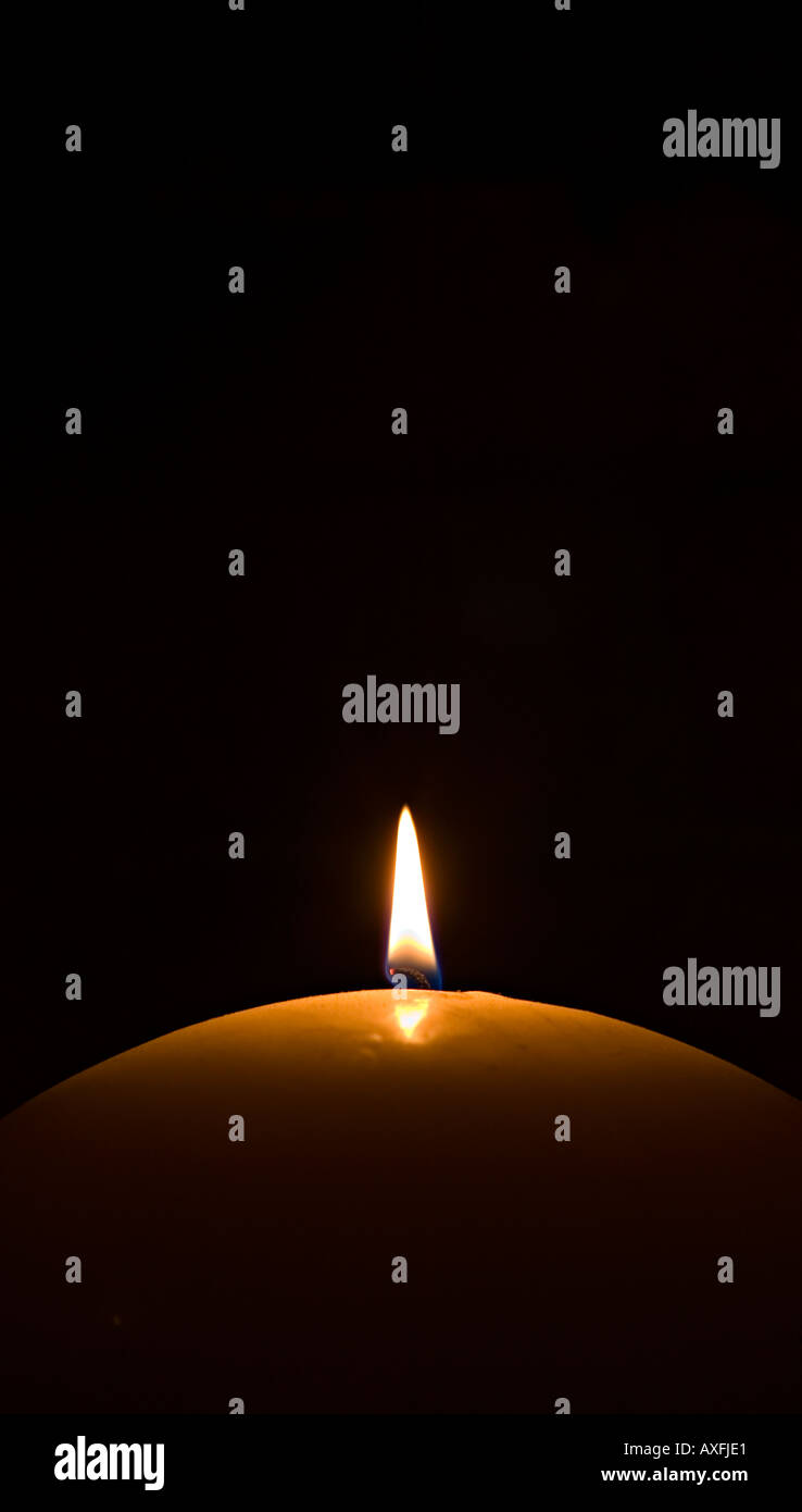 Candle flame against black background Stock Photo