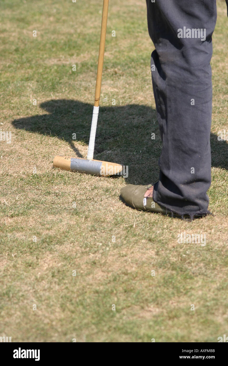 Polo groom holding spare polo stick at the Gold Cup Finals, Cowdray