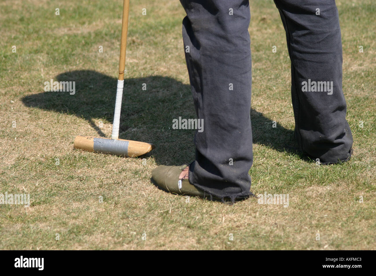 Polo groom holding spare polo stick at the Gold Cup Finals, Cowdray