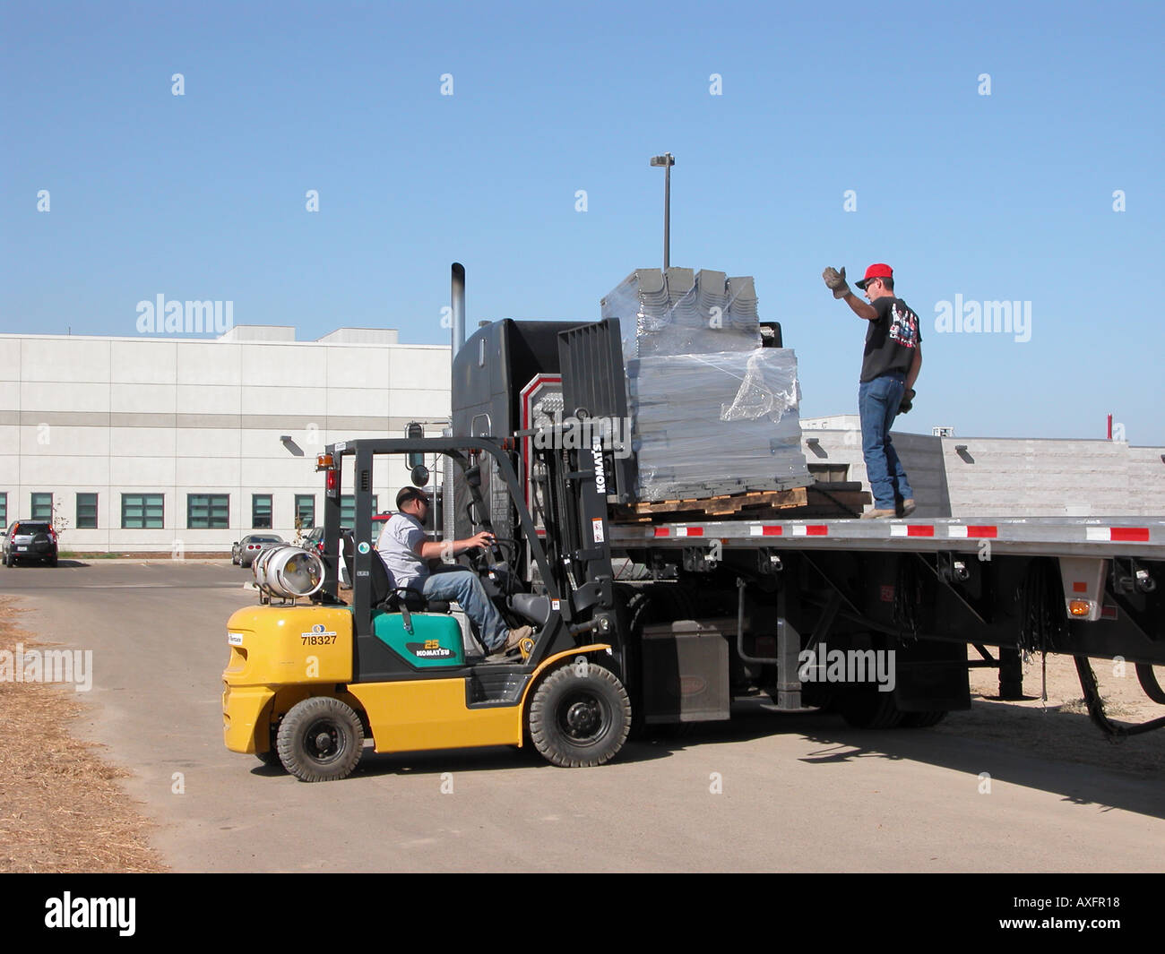 Forklift Loading A Flat Bed Truck Stock Photo Alamy