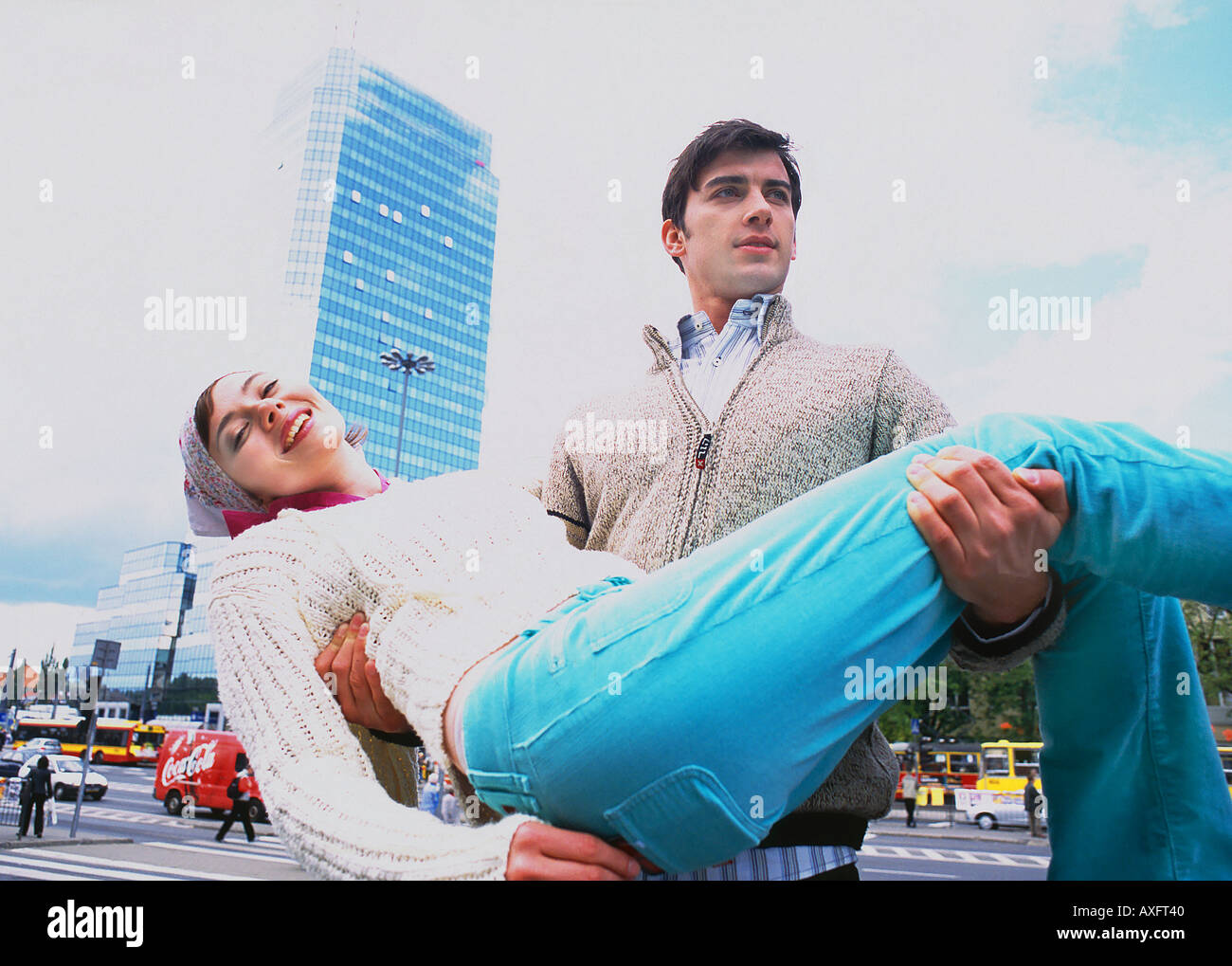 outdoor day spring city street office building buildings skyscraper couple man young woman girl 20 25 dark haired bandana sca Stock Photo