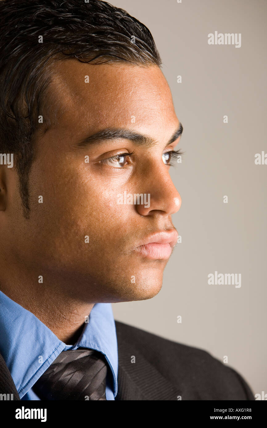 Young man wearing a collar and tie looking intently Stock Photo