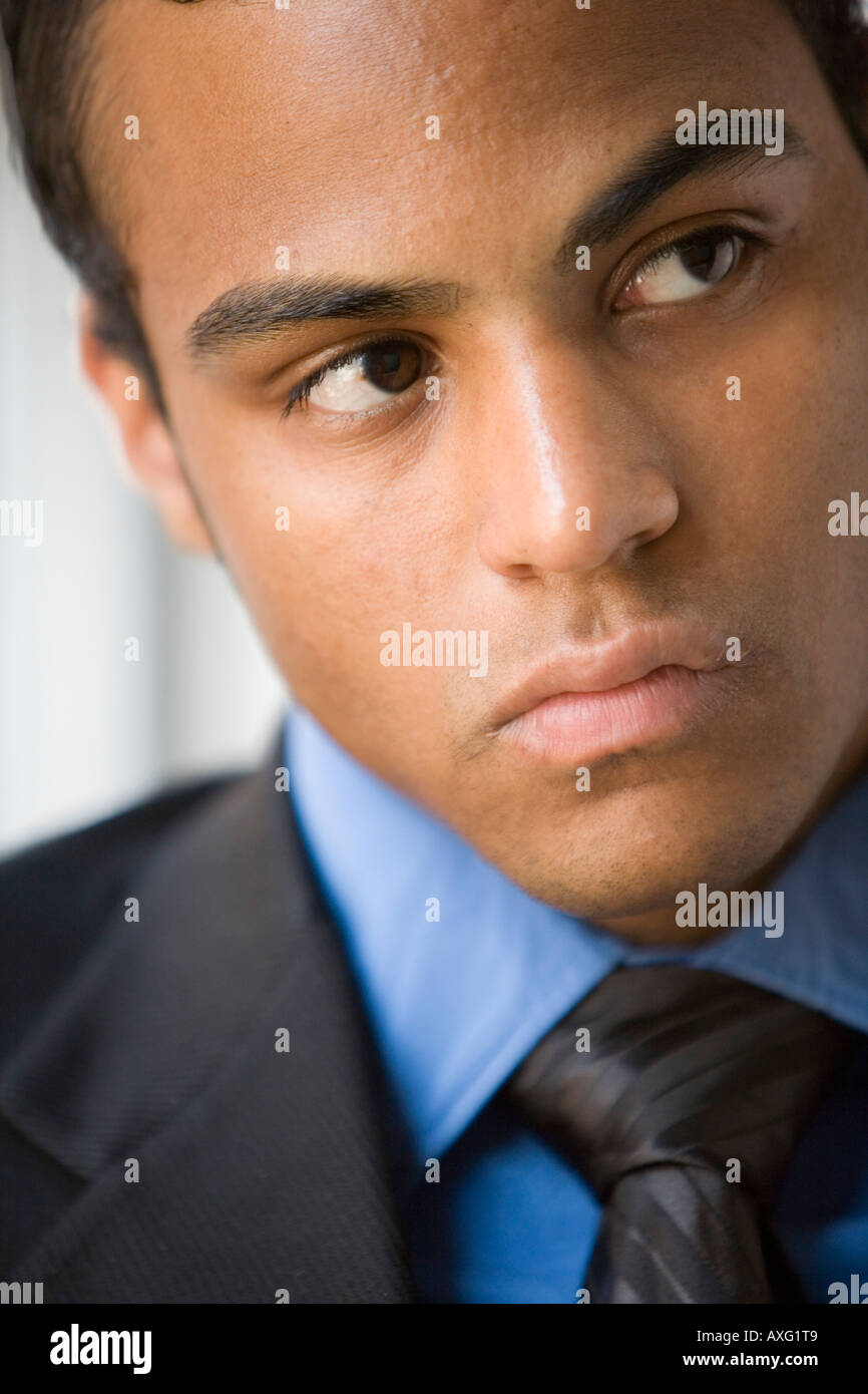 Close up of a young dark skinned business man looking very serious Stock Photo