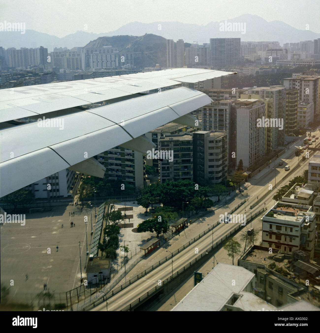 View from an airliner over the aircraft’s wing with flaps down on one of last flights to old Kai Tak airport Hong Kong Stock Photo