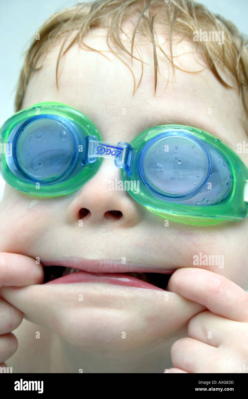 Four year old in swimming goggles pulling funny Stock Alamy