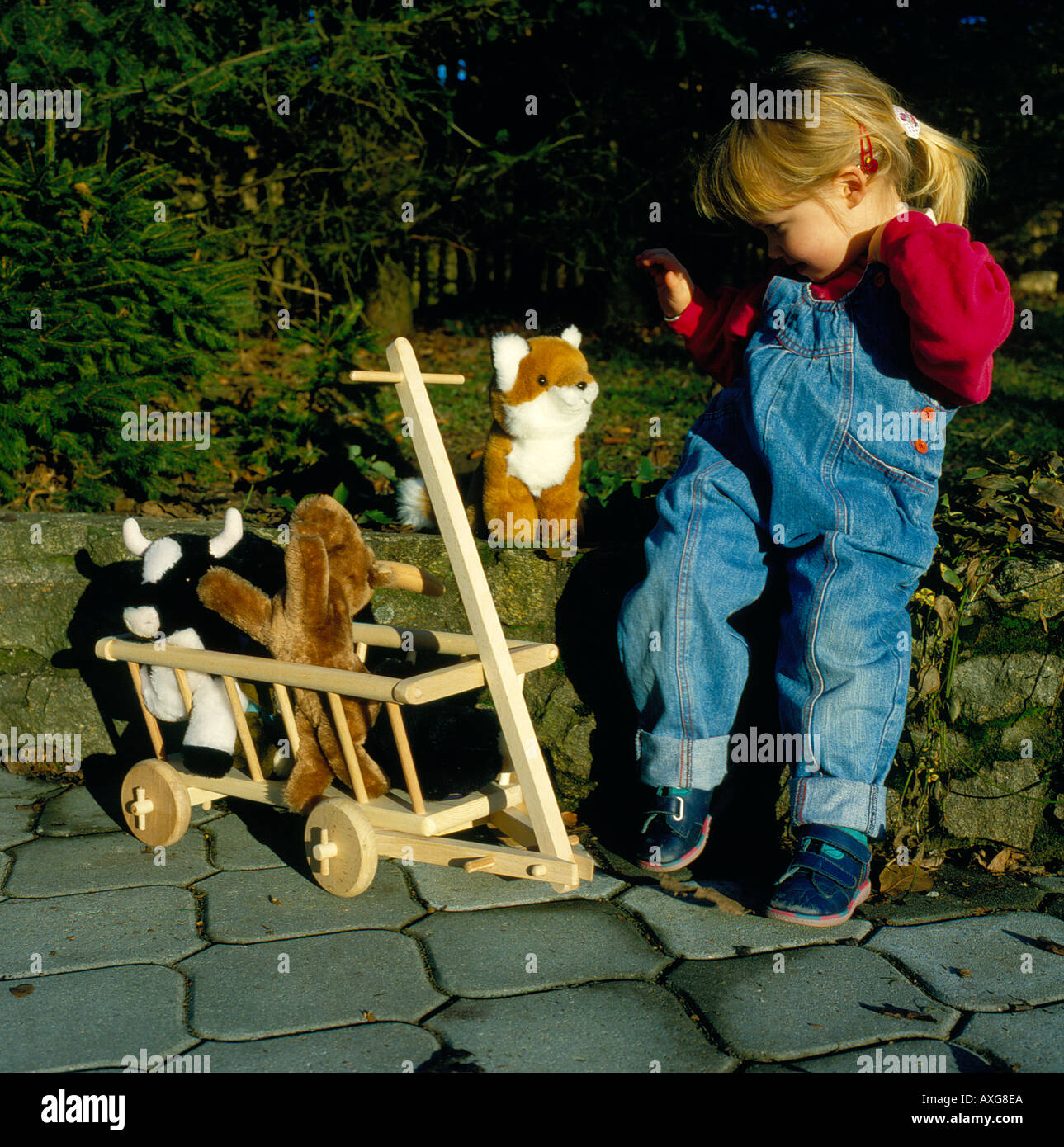 young girl playing with stuffed animals. Photo by Willy Matheisl Stock ...