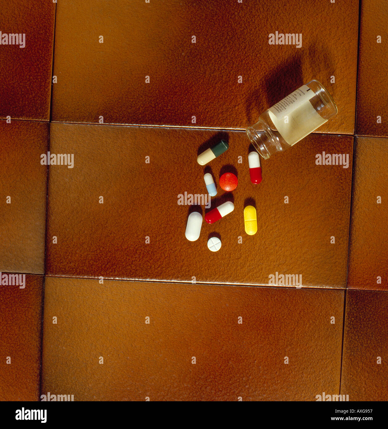 drugs falling out of a glass bottle. Photo by Willy Matheisl Stock Photo