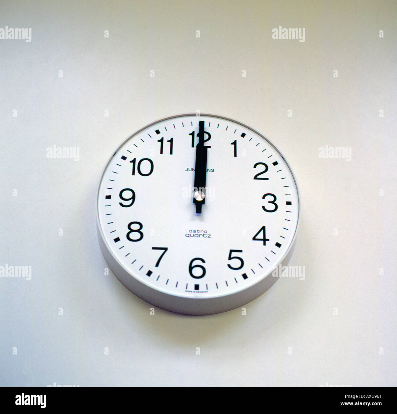 Analog clock showing twelve o clock noon. Photo by Willy Matheisl Stock Photo