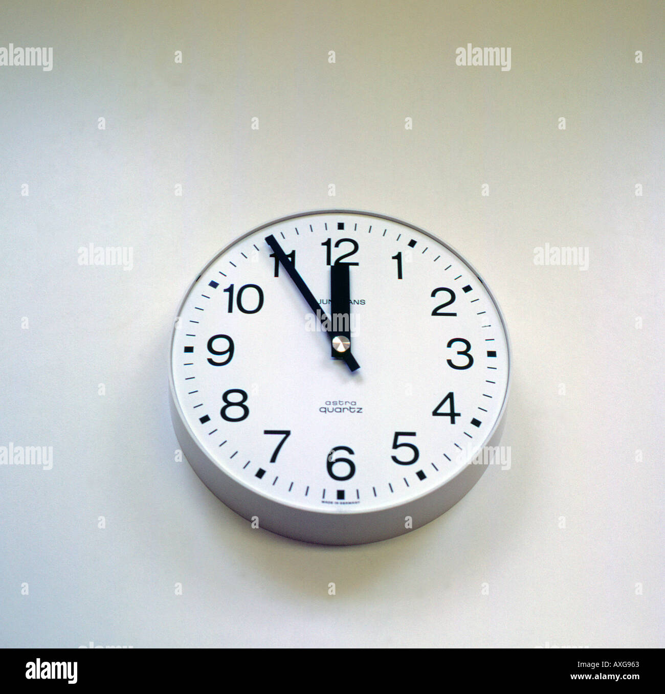 clock analoge face showing five before twelve. Photo by Willy Matheisl