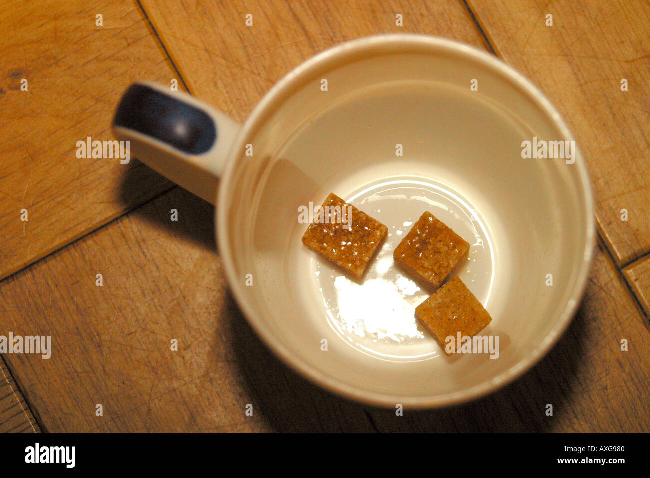 Coffee mug with brown sugar cubes Stock Photo