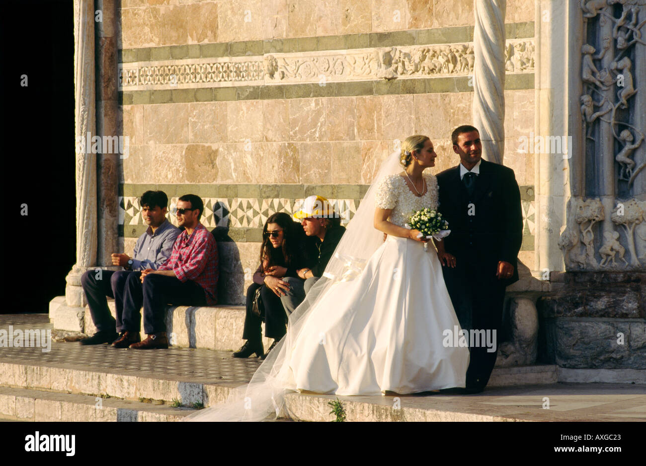 Messina Cathedral, Sicily, Italy. Bride and groom pose for wedding photographs on steps of west façade. Stock Photo