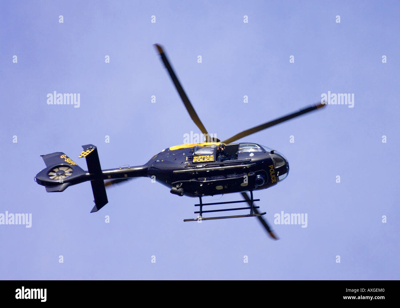 a police photographer taking photos of an area where a fatal accident occurred from a Police helicoptor in Suffolk Stock Photo