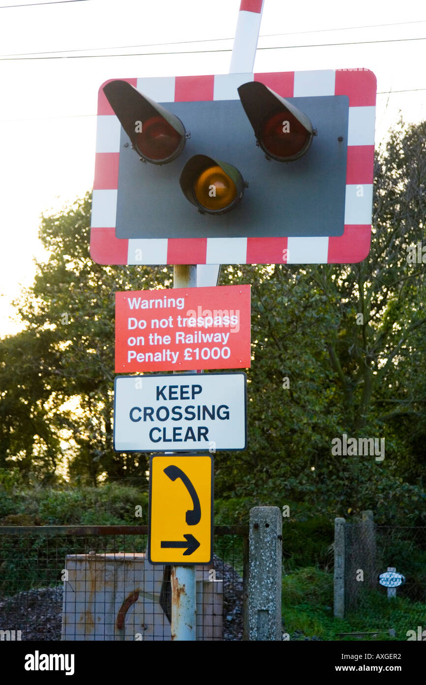 flashing warning sign at a railway crossing Stock Photo