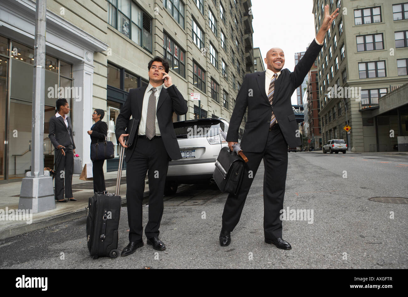 Businessmen Hailing Taxi, New York City, New York, USA Stock Photo