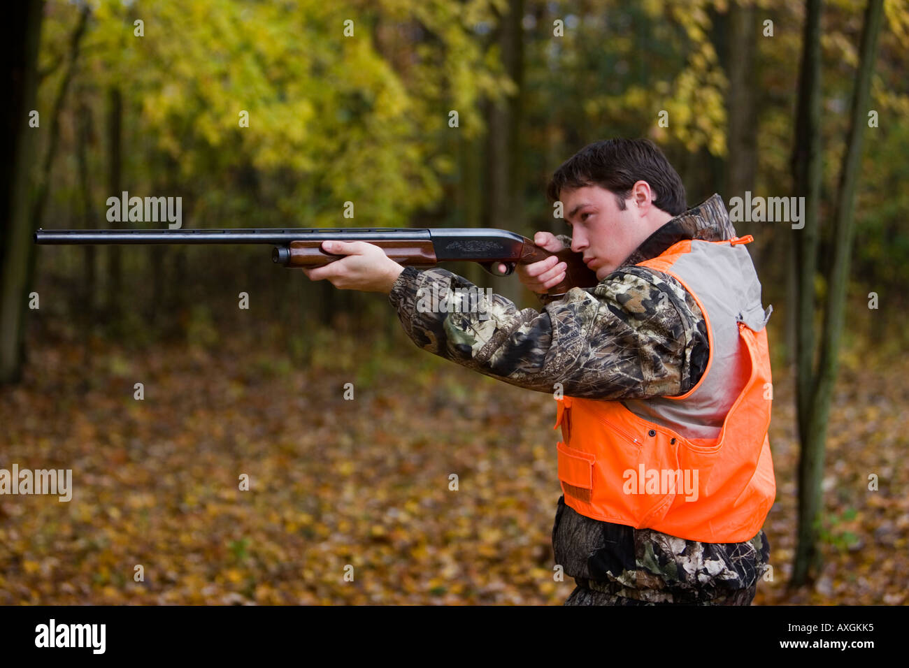 Hunter aiming a rifle Stock Photo