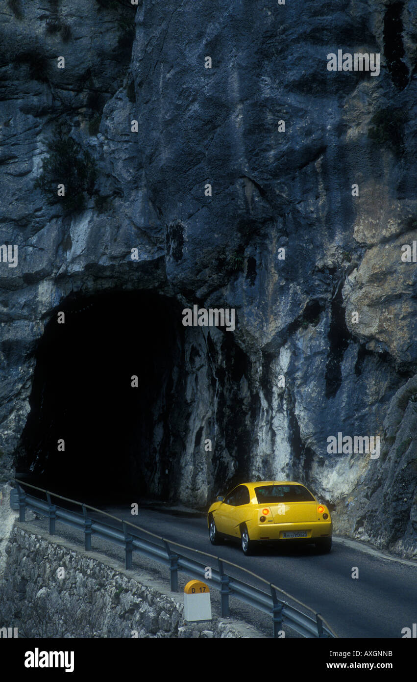 Yellow car entering tunnel on D17 road in the French Alps Stock Photo