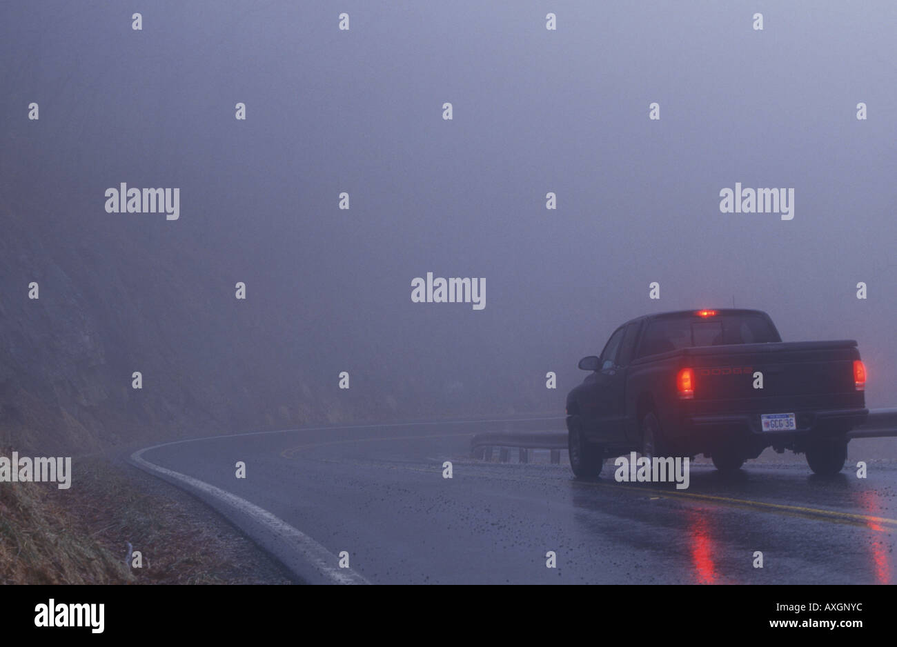 Truck driving in thick fog Stock Photo